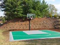 Green personal basketball court in Bridgewater, MA.