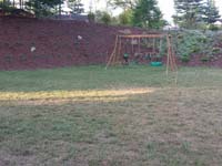 Future site of green and silver backyard basketball court in Bridgewater, MA.