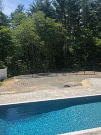 Before picture overlooking pool toward bare area of yard where blue and gray residential basketball court in Easton, MA will be.