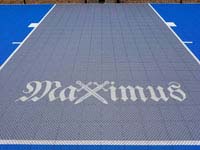 The name Maximus with crossed swords for the X, in honor of the court owner's son.