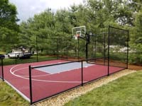 View of red and silver personal basketball court in Groton, MA.
