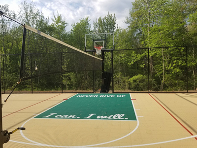 Backyard basketball court with custom logo and net for sports like tennis and volleyball in Londonderry, NH..