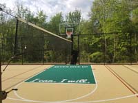 Sand-colored and green basketball court, with optional net for tennis and volleyball, in Londonderry, NH.