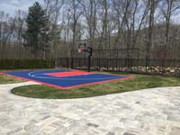 Navy blue and red New England home basketball court shown after associated landscape improvements were complete in North Attleboro, MA.