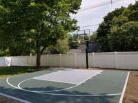 Small slate green and titanium residential basketball court in Reading, MA.