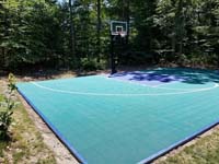 Emerald green and navy blue Versacourt basketball tile on blacktop court in Rehoboth, MA.