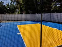 Royal blue and yellow basketball court and accessories in Stoneham, MA.