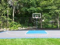Graphite and light blue backyard basketball court installed in West Bridgewater, MA.
