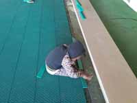 Resurfaced ABBA (Antigua and Barbuda Basketball Association) basketball court and replaced hoops at JSC Sports Complex in Piggotts, Antigua and Barbuda. Youngster getting involved in finishing touches on new court tiles.