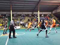 Resurfaced ABBA (Antigua and Barbuda Basketball Association) basketball court and replaced hoops at JSC Sports Complex in Piggotts, Antigua and Barbuda. Players and official in action during second game of season on new court surface.