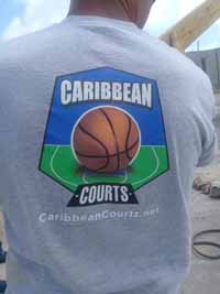 Replacement tennis and basketball courts in Codrington, Barbuda, courtesy of Australia, the Red Cross, and community effort, part of the ongoing recovery from hurricane Irma. Shown here, Bob Whyte in Caribbean Courts shirt while helping to remove old basketball goal post.