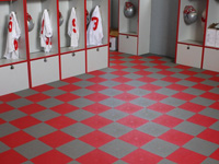 This sample picture shows red and grey tile installed in a locker room. The tile allows water to flow through to the concrete floor below.